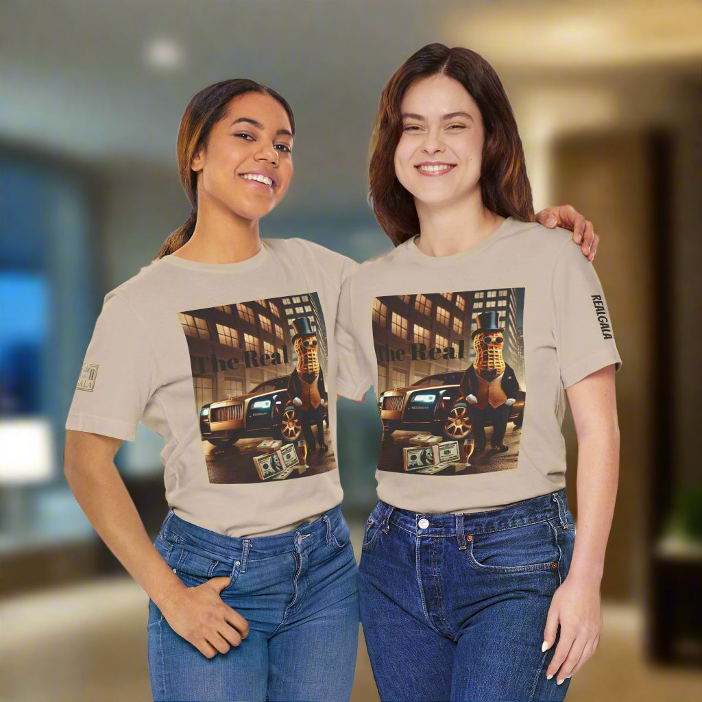 Two women wearing matching Luxury Tee beige shirts with bold graphic of peanut in suit, car, and cash, styled for trendy urban fashion.