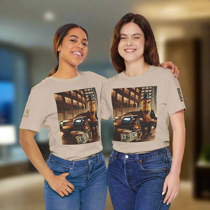 Two women wearing matching Luxury Tee beige shirts with bold graphic of peanut in suit, car, and cash, styled for trendy urban fashion.